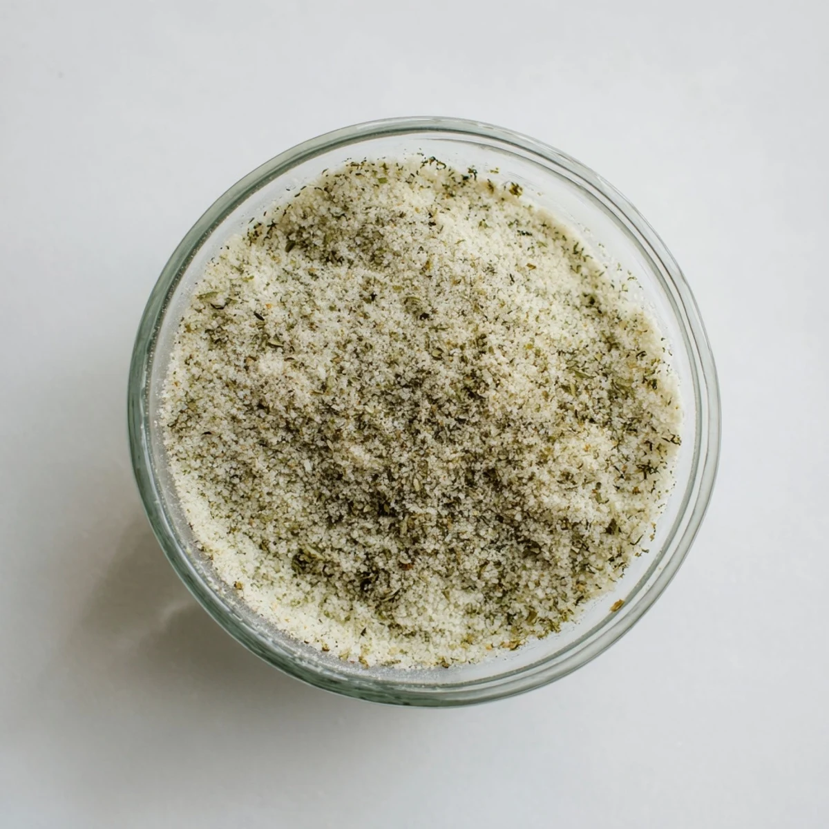 Vibrant overhead shot: Easy-to-make garlic salt seasoning in a glass jar, ready to use.