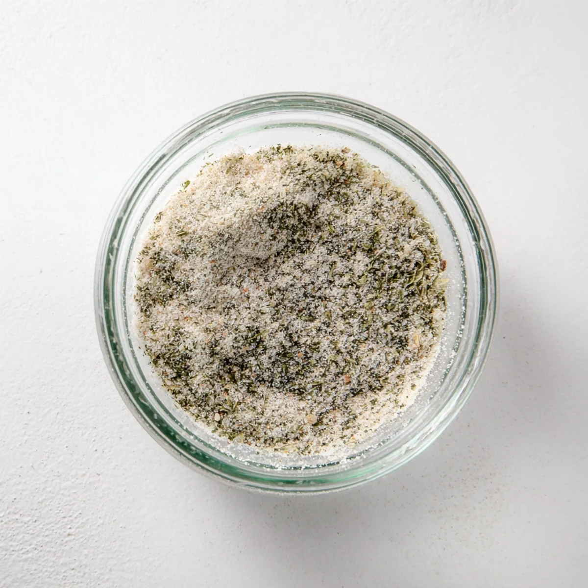 Close-up of garlic salt seasoning, ready to be sprinkled, showcasing the texture in bright light.