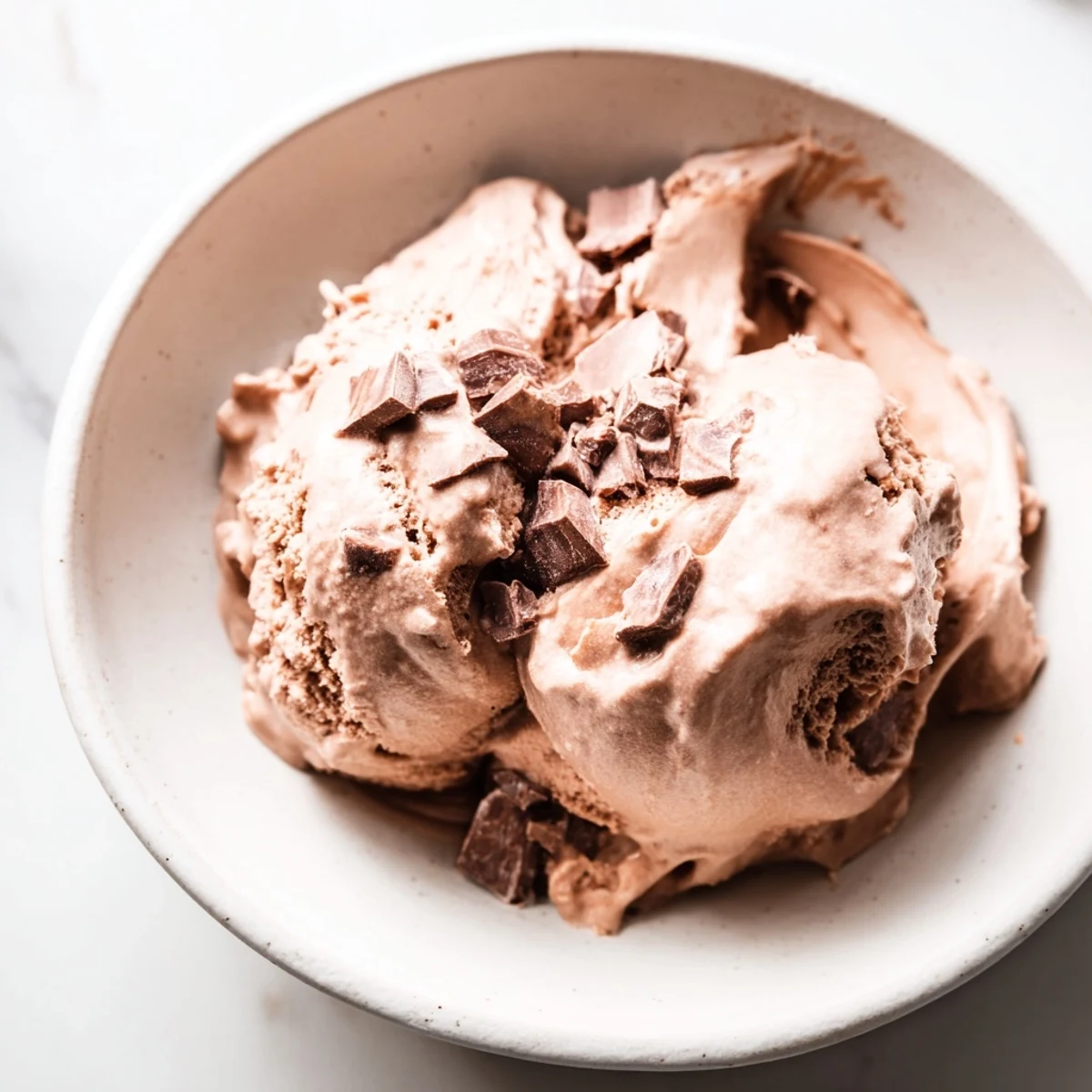 Luscious chocolate ice cream, close-up, showing its smooth texture, ready to enjoy.