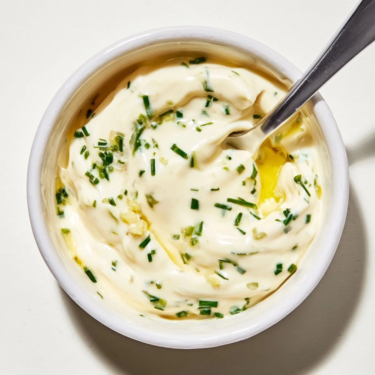 This homemade creamy dressing looks incredibly smooth, ready to be drizzled over a vibrant salad.