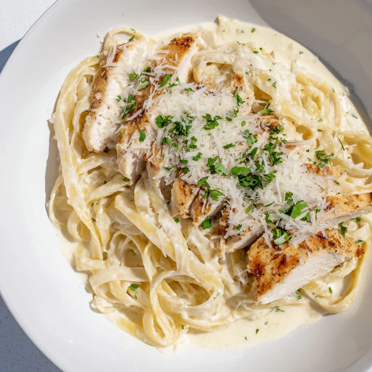 Close-up of a plate of creamy chicken Alfredo, a rich Italian-American classic.
