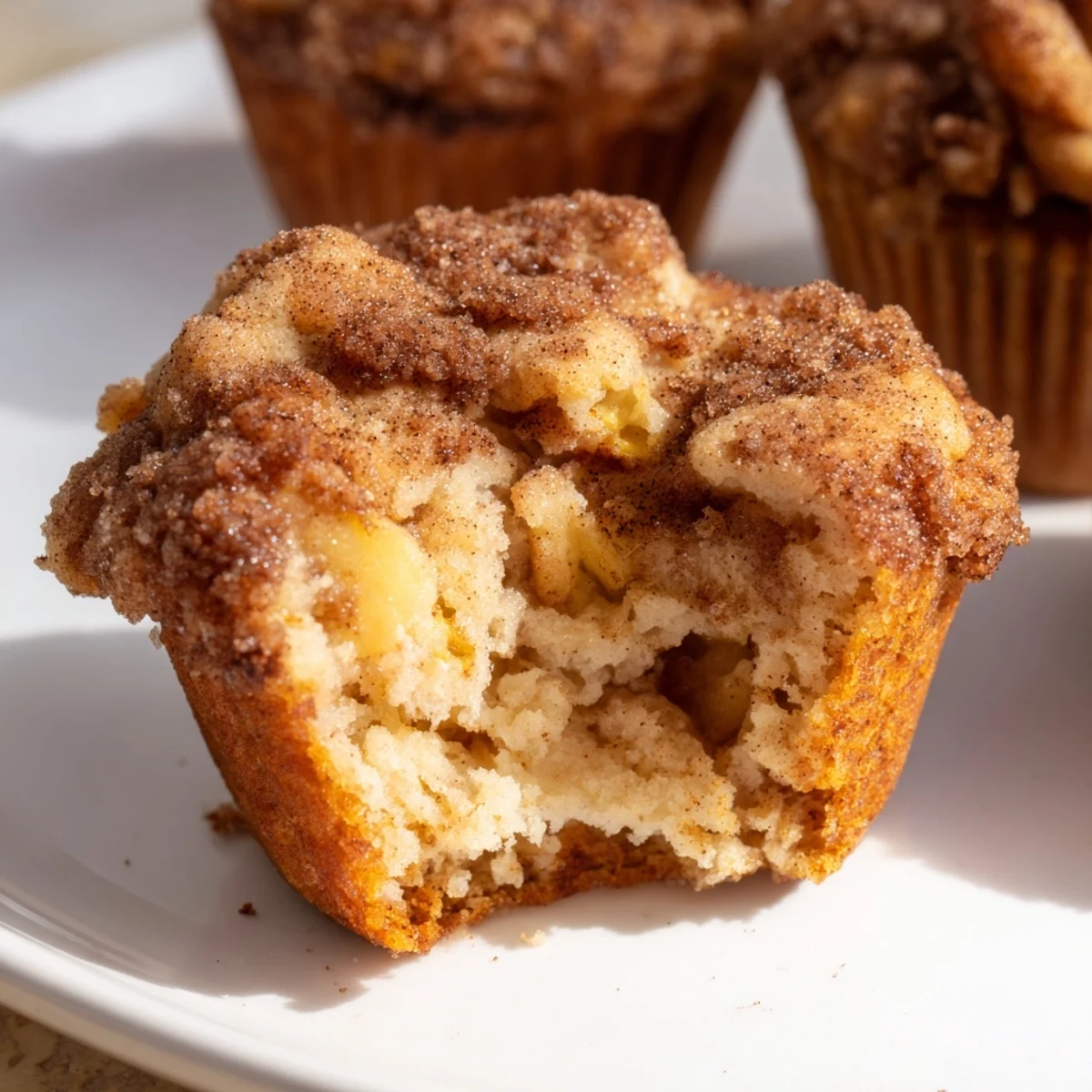 Close-up of fluffy Cinnamon Apple Muffins, fresh from the oven, offering a tempting texture.