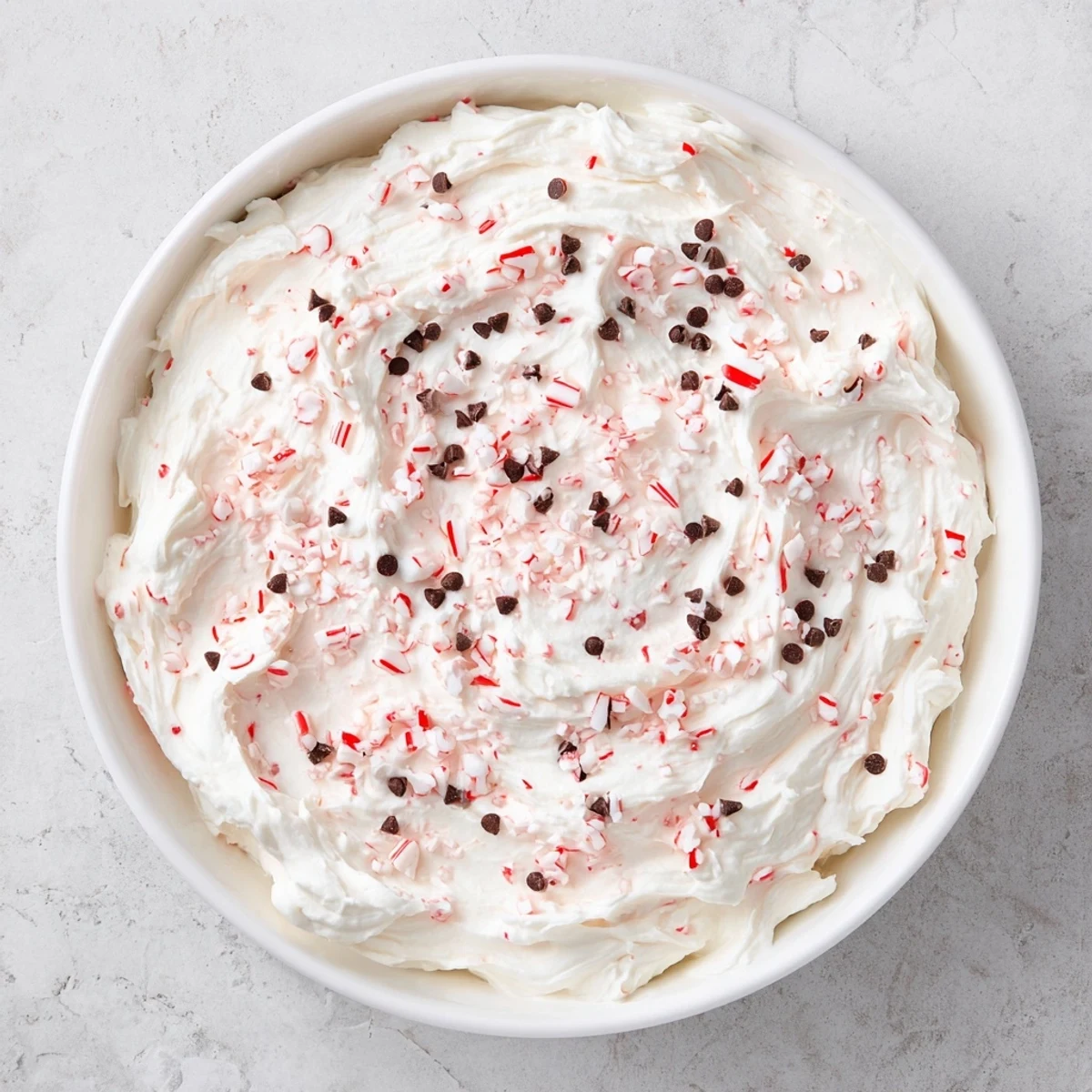 Peppermint Fluff Dip is a smooth, festive dessert, garnished with crushed peppermint candies.
