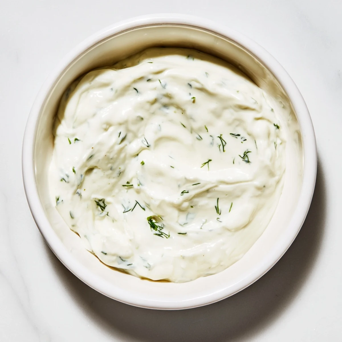 Delicious creamy ranch dressing swirled with fresh herbs, ready for dipping crisp vegetables.