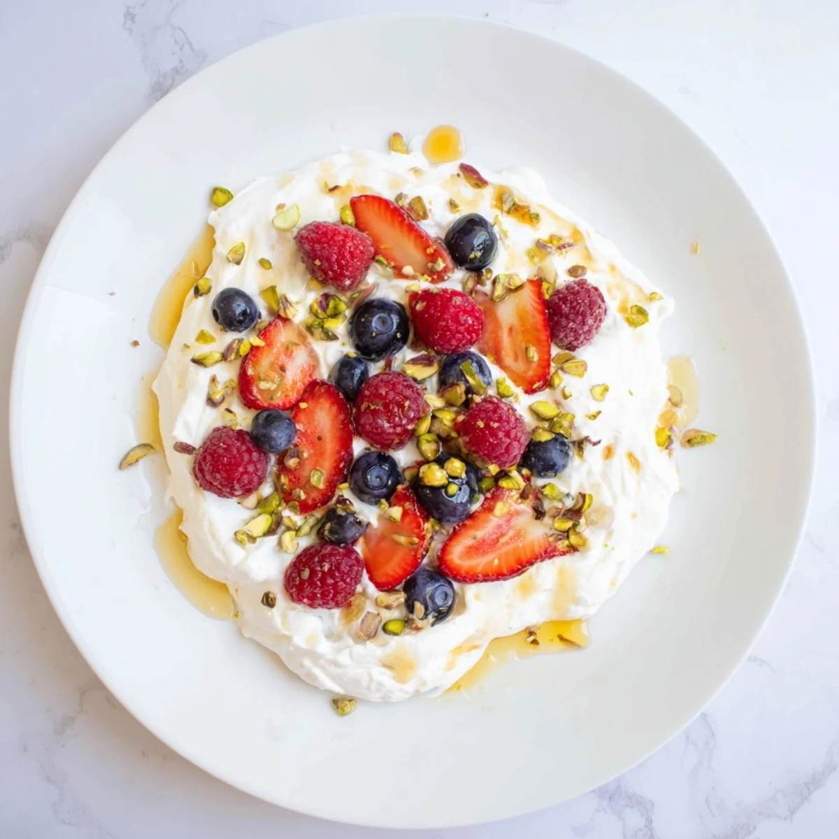 The image depicts a bowl of creamy yogurt, swirled with vanilla, and fresh fruit for a perfect treat.