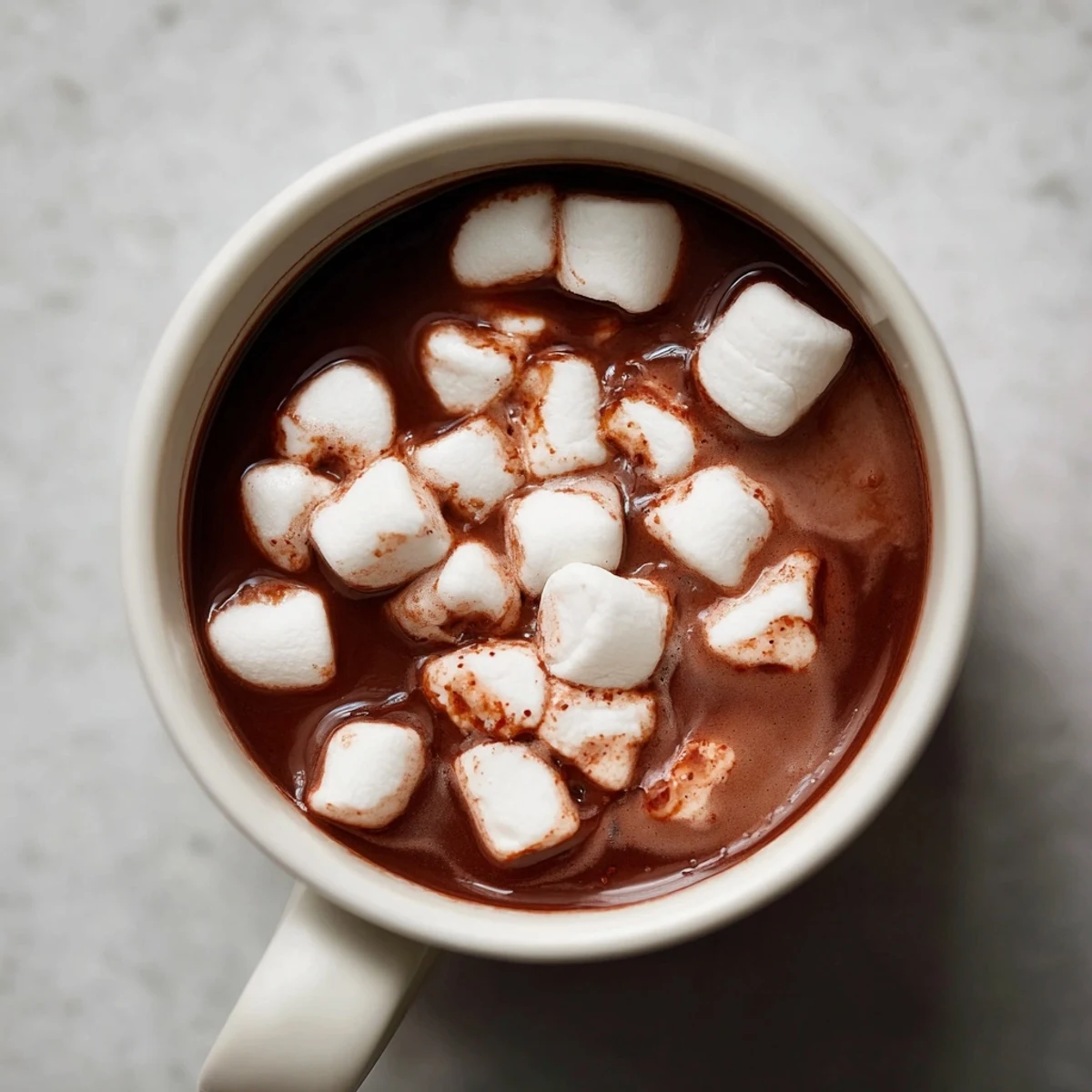 A close-up of a mug of Spiced Hot Chocolate, topped with fluffy white marshmallows, looking delicious.