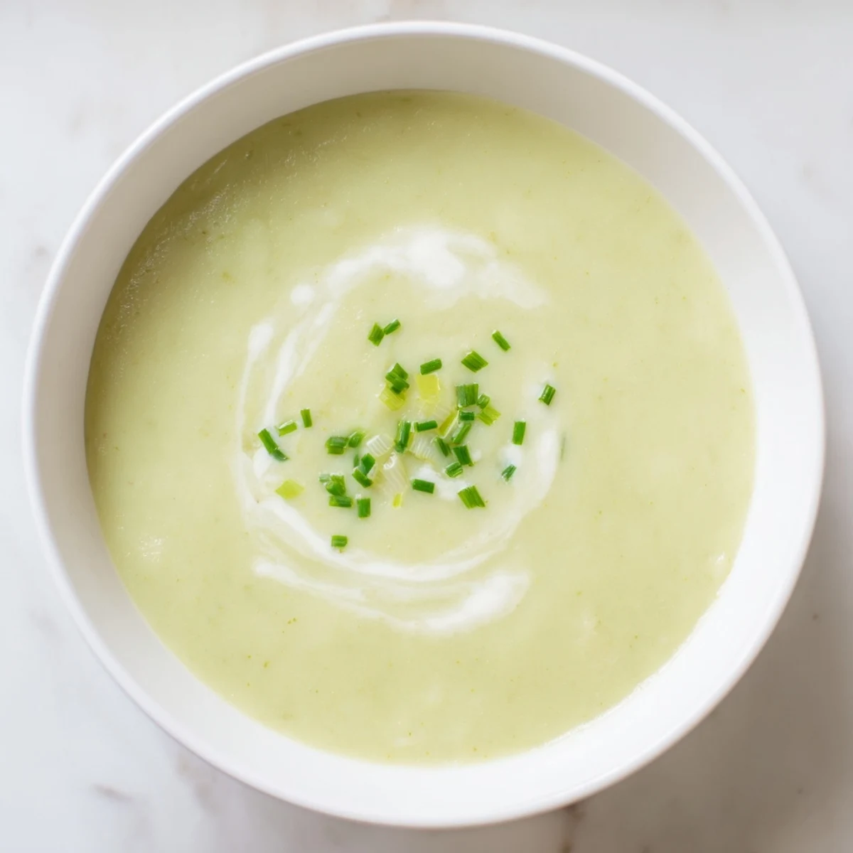 Creamy Leek Soup, a smooth and velvety texture, topped with fresh chives for serving.