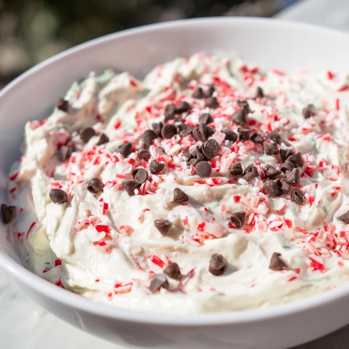 A close-up of creamy Peppermint Fluff Dip, perfect with chocolate cookies and graham crackers.
