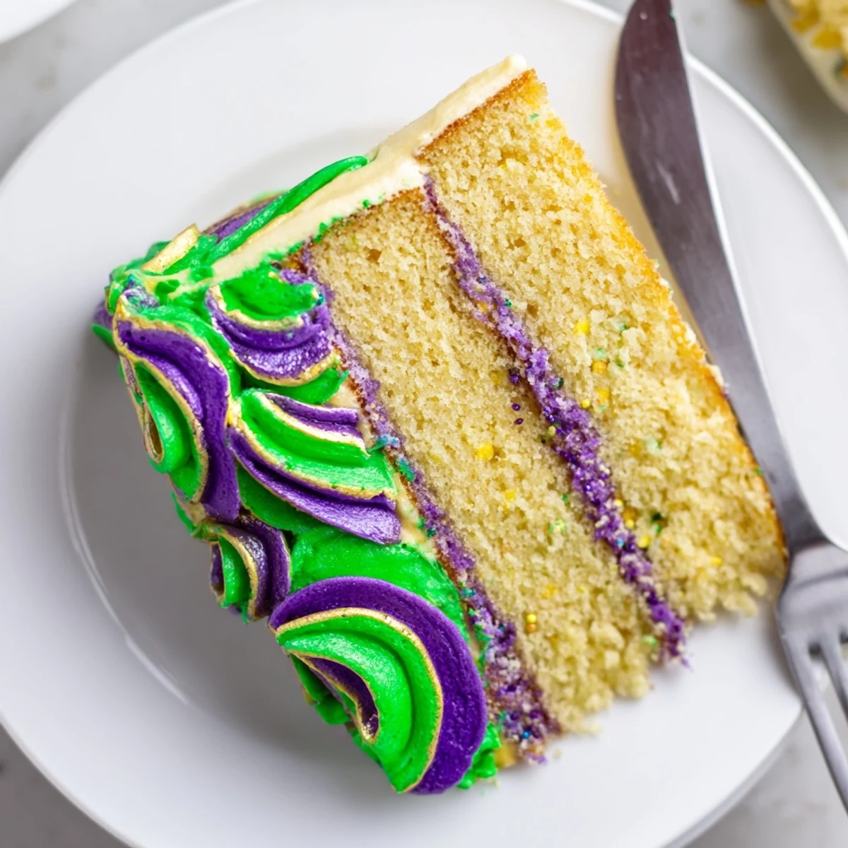 A beautifully decorated Mardi Gras Cake with tricolor icing in purple, green, and gold.