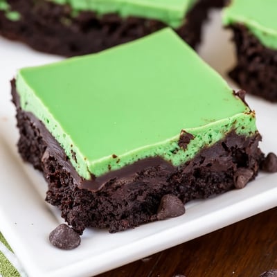Moist Green Mint Brownies with Chocolate Chips served chilled with a dusting of powdered sugar.