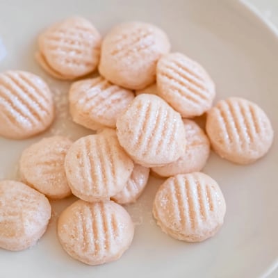 Confiseries crémeuses à l'orange décorées avec des marques de fourchette sur du papier parchemin